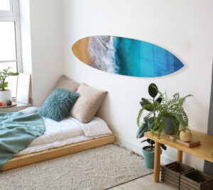 Three custom acrylic surfboard prints displayed on wall near kitchen — beach photo wall art by PrintMyJourney